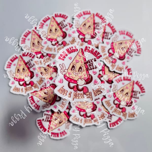 A pile of Joey's New York Pizza stickers featuring a cartoon pizza slice with hearts and text.